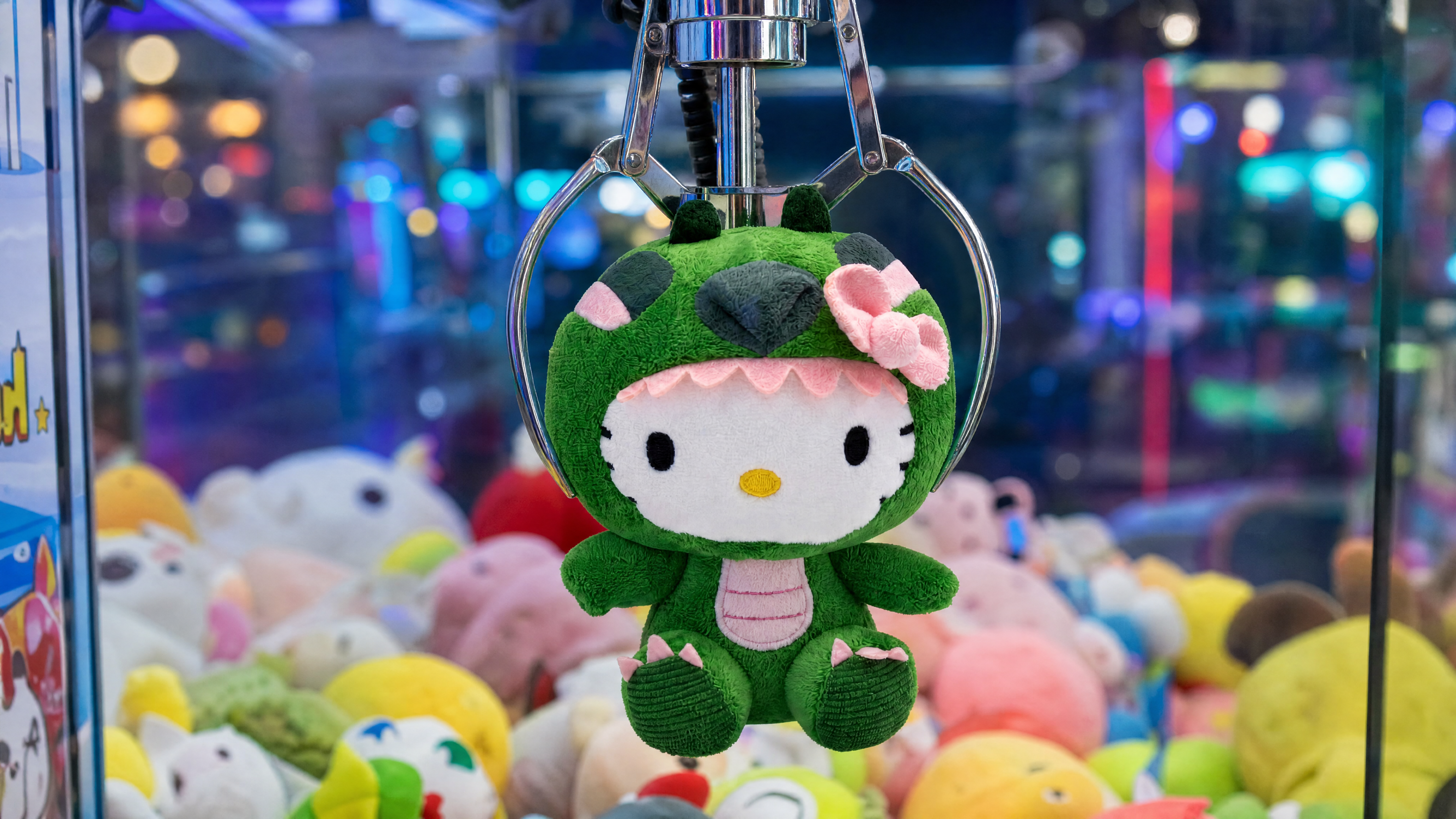 A family playing a plush crane machine