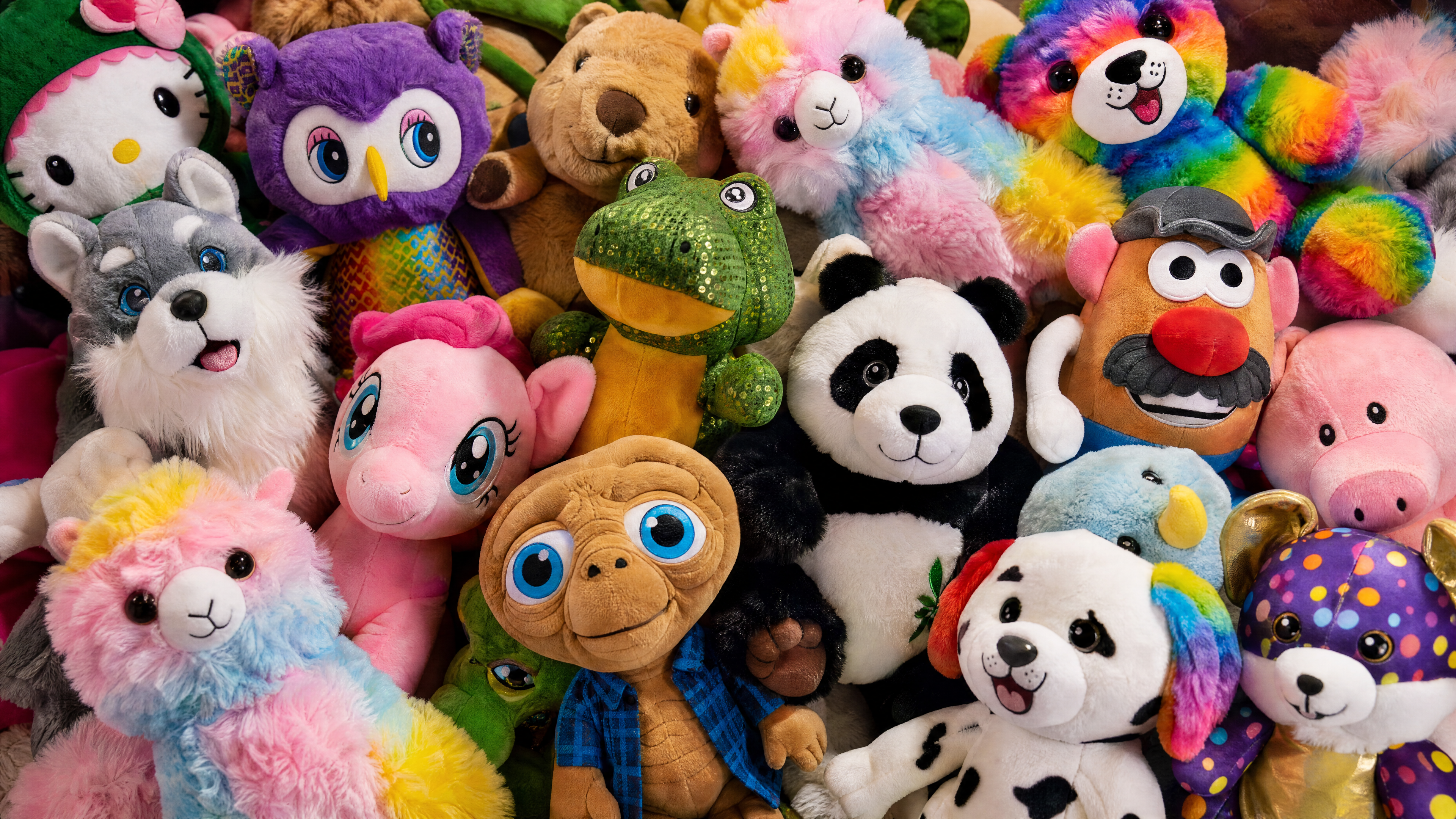 A colorful assortment of plush animals and character prizes